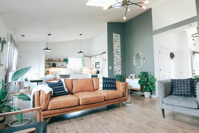 Open-plan living room with a leather sofa and hardwood floor