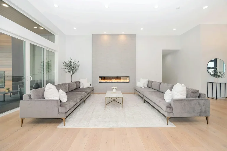 Bright living room with light wood flooring and a modern fireplace