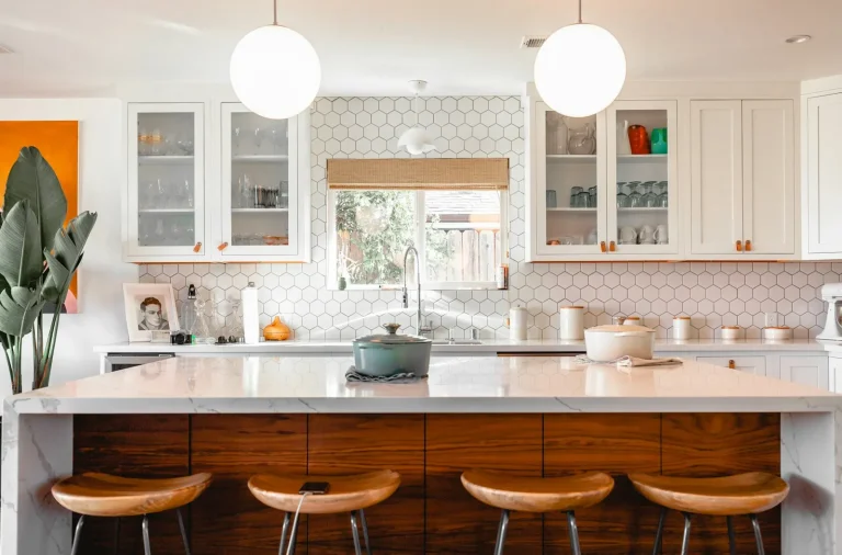 Kitchen with an island, pendant lights and bar stools